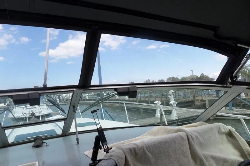 Slide: The Image of View from 1994 Sea Ray 370 Express Cruiser cockpit, overlooking marina and clear sky. - 51