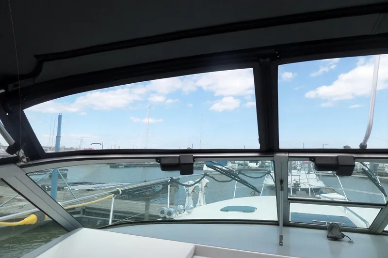 Slide: The Image of View from 1994 Sea Ray 370 Express Cruiser cockpit, overlooking marina and blue sky. - 52