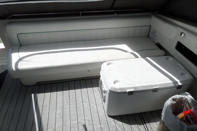 Slide: The Image of Interior of a 1994 Sea Ray 370 Express Cruiser with seating and cooler. - 6