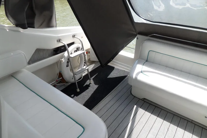 Slide: The Image of Interior of a 1994 Sea Ray 370 Express Cruiser with white seating and life preserver. - 7