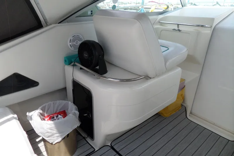 Slide: The Image of Interior of 1994 Sea Ray 370 Express Cruiser with seating, fan, and trash bin. - 9