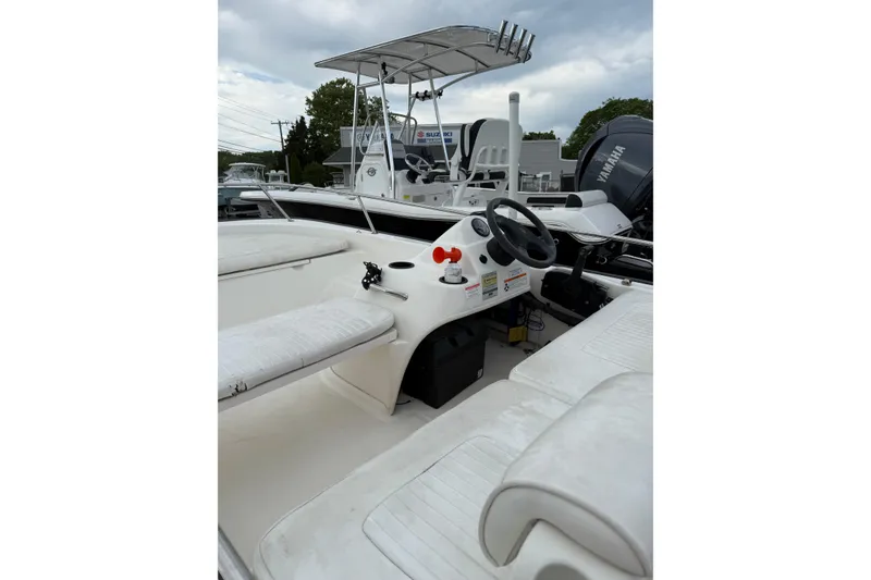 Slide: The Image of 2006 Boston Whaler 150 Sport boat interior with steering wheel and seating. - 6