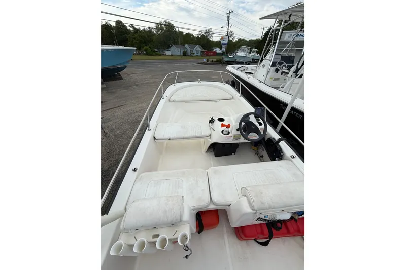 Slide: The Image of 2006 Boston Whaler 150 Sport boat interior with steering wheel and seating. - 9