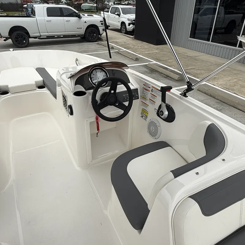 Slide: The Image of Interior of 2025 Bayliner E18LE with steering console and seating area. - 11