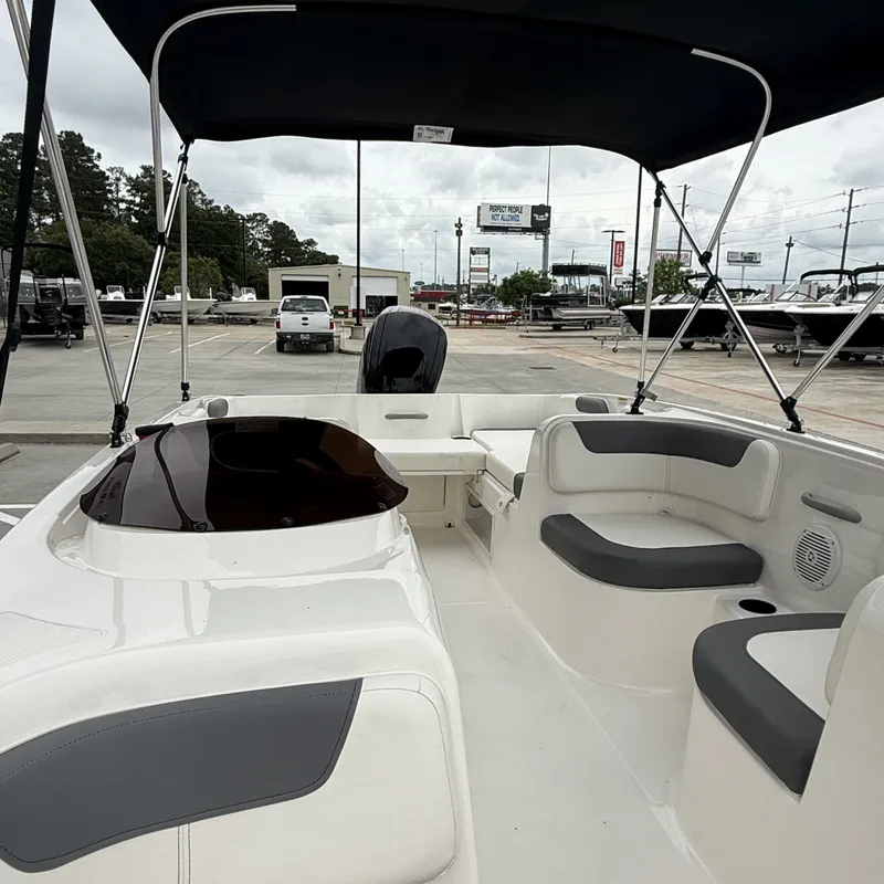 Slide: The Image of Interior view of 2025 Bayliner E18LE boat with seating area. - 14