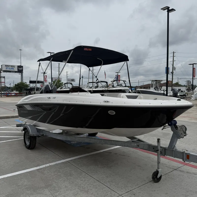 Slide: The Image of 2025 Bayliner E18LE boat on trailer under cloudy sky. - 3