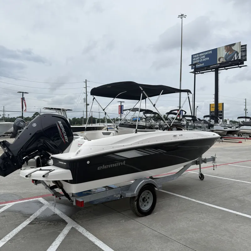 Slide: The Image of 2025 Bayliner E18LE boat on a trailer outdoors. - 5
