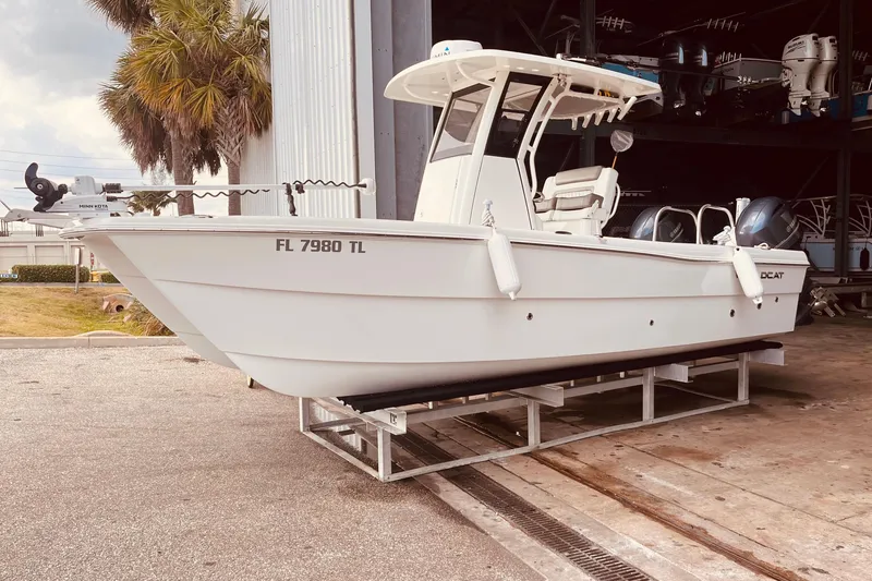 The Image of 2023 World Cat 235 CC boat on trailer, parked near a storage facility. - 0
