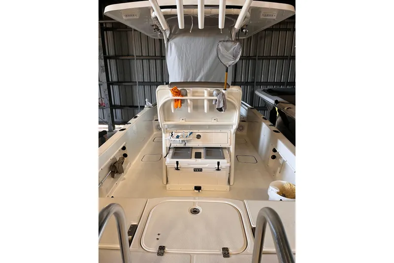 Slide: The Image of 2023 World Cat 235 CC boat interior with fishing gear and storage compartments. - 4