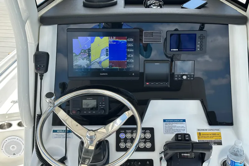 Slide: The Image of 2023 World Cat 235 CC boat dashboard with Garmin navigation and Yamaha controls. - 5
