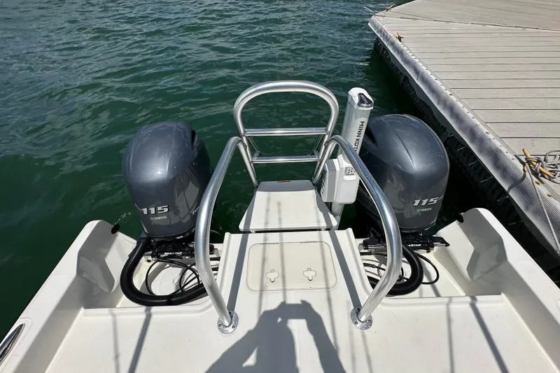 Slide: The Image of 2023 World Cat 235 CC boat with dual Yamaha 115 engines at dock. - 6