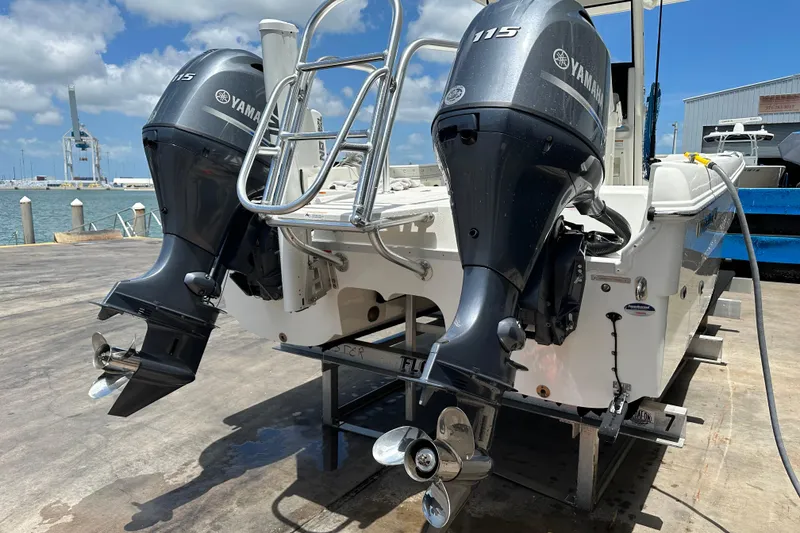 Slide: The Image of 2023 World Cat 235 CC boat with dual Yamaha 115 engines at dockside. - 8