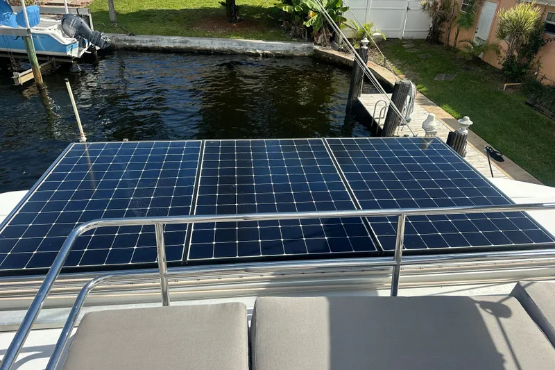 Slide: The Image of Solar panels on a 2019 Fountaine Pajot 47 catamaran docked by the water. - 14
