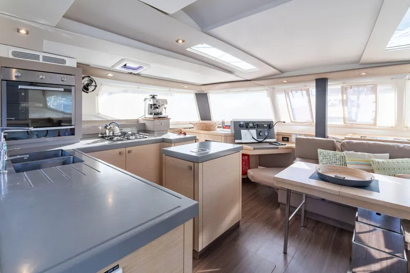 Slide: The Image of Luxurious interior of 2019 Fountaine Pajot 47 catamaran with modern kitchen and seating area. - 19