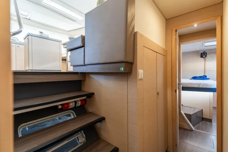 Slide: The Image of Interior of 2019 Fountaine Pajot 47 yacht, featuring modern stairs and cozy cabin. - 64