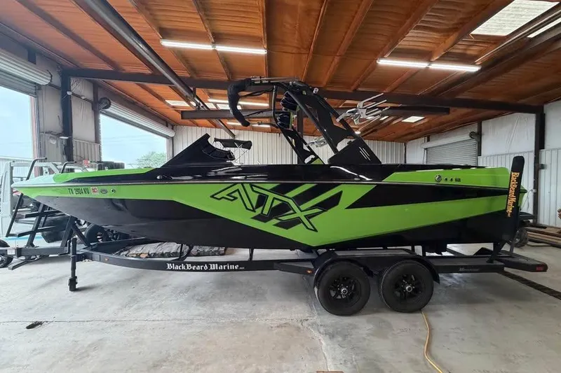 The Image of 2022 ATX Surf Boats 24 Type-S in a garage, vibrant green and black design. - 0
