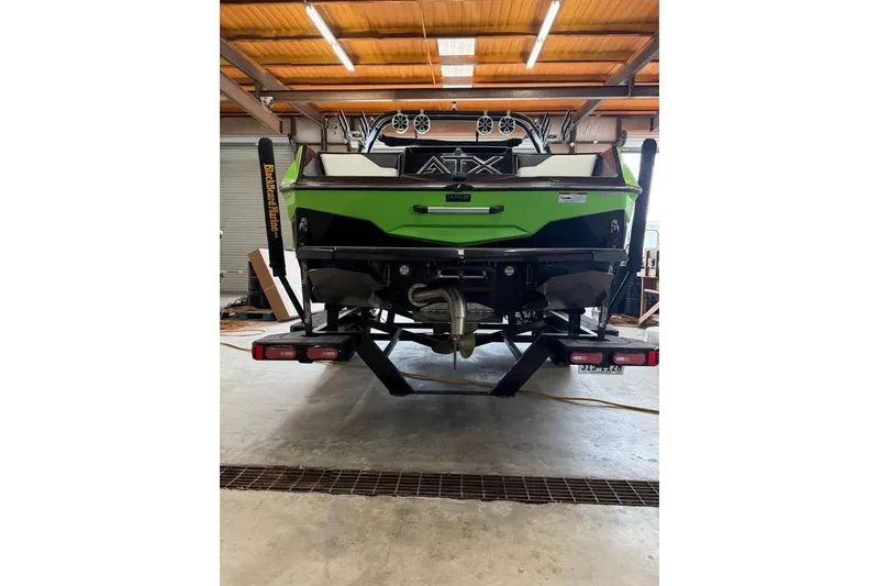 Slide: The Image of 2022 ATX Surf Boats 24 Type-S in a garage, showcasing its sleek green design. - 3