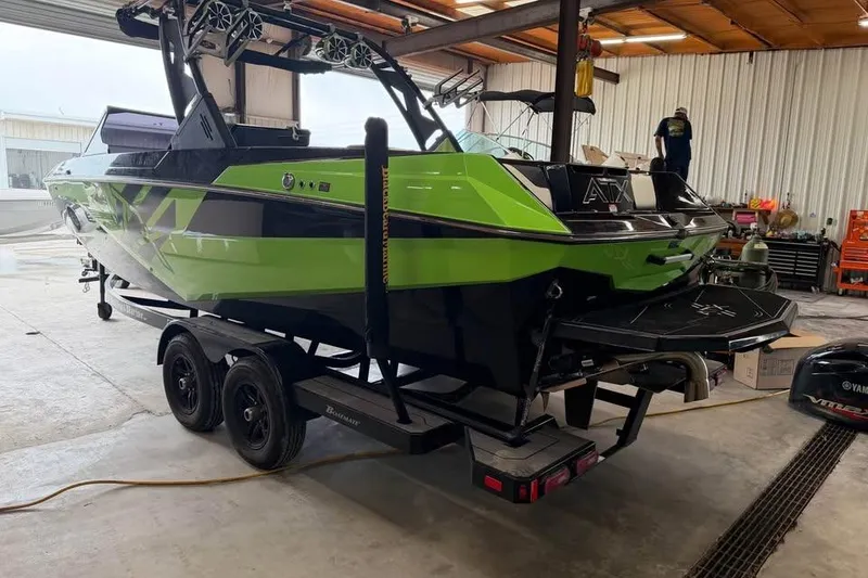 Slide: The Image of 2022 ATX Surf Boats 24 Type-S in a garage, vibrant green and black design. - 4