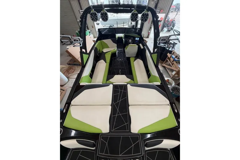 Slide: The Image of 2022 ATX Surf Boats 24 Type-S interior with green and white seating, black accents. - 8
