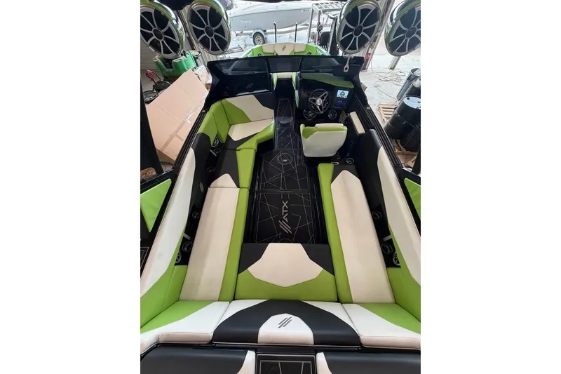 Slide: The Image of 2022 ATX Surf Boats 24 Type-S interior with green and white seating, sleek design. - 9