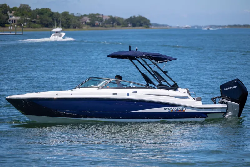 The Image of 2024 Monterey M-45 boat cruising on a serene lake with a Mercury engine. - 0