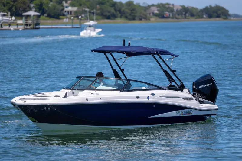 Slide: The Image of 2024 Monterey M-45 boat cruising on a sunny lake with a Mercury engine. - 10