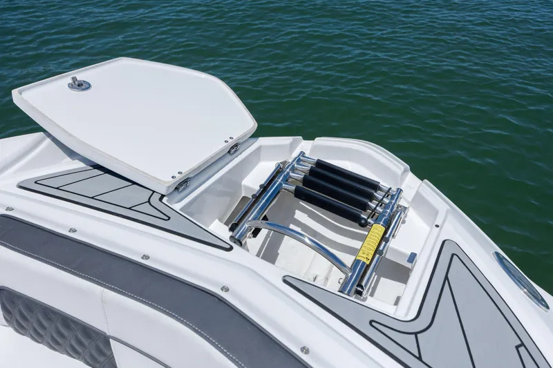 Slide: The Image of 2024 Monterey M-45 boat with open storage compartment and ladder on calm water. - 12