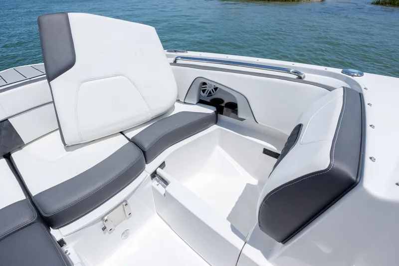 Slide: The Image of 2024 Monterey M-45 boat interior with white and gray seating, on a calm blue lake. - 14