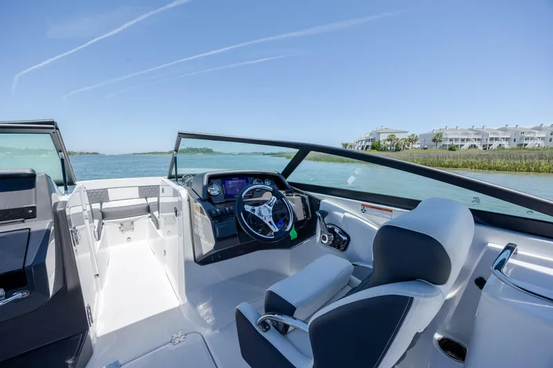 Slide: The Image of 2024 Monterey M-45 boat interior with modern dashboard and scenic water view. - 18