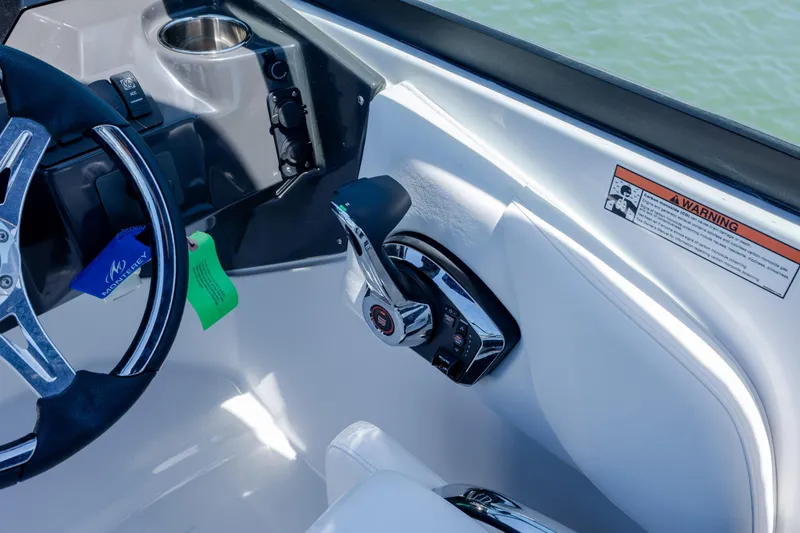 Slide: The Image of 2024 Monterey M-45 boat cockpit with steering wheel and control panel, featuring warning label. - 21