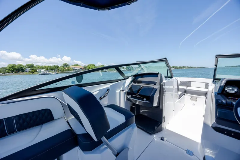 Slide: The Image of 2024 Monterey M-45 boat interior with sleek seating and modern dashboard on a sunny day. - 22