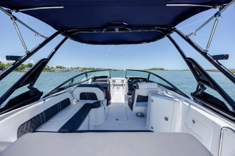 Slide: The Image of 2024 Monterey M-45 boat interior with seating and helm, on calm water. - 25
