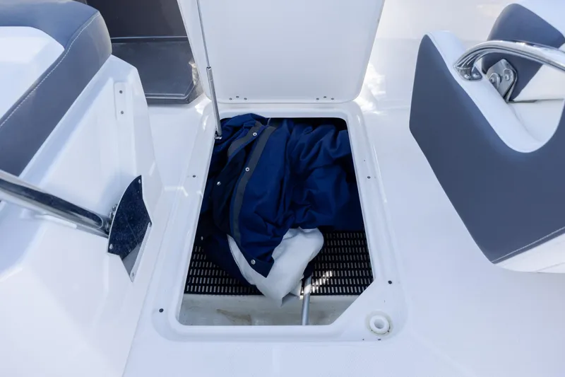 Slide: The Image of Storage compartment on a 2024 Monterey M-45 boat, featuring a blue jacket inside. - 26