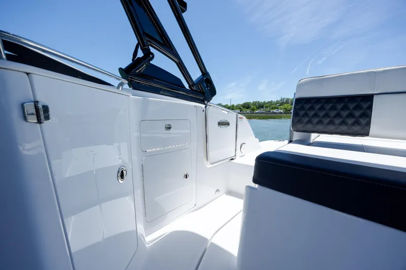 Slide: The Image of 2024 Monterey M-45 boat interior with sleek seating and storage, under clear blue sky. - 27