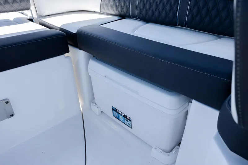 Slide: The Image of 2024 Monterey M-45 boat interior with cushioned seating and built-in cooler storage. - 32