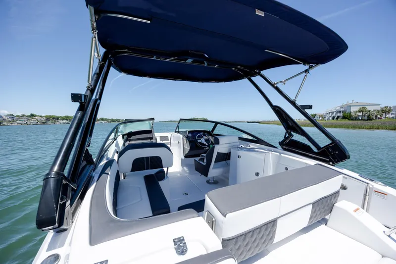 Slide: The Image of 2024 Monterey M-45 boat interior with seating and canopy on a sunny day. - 33
