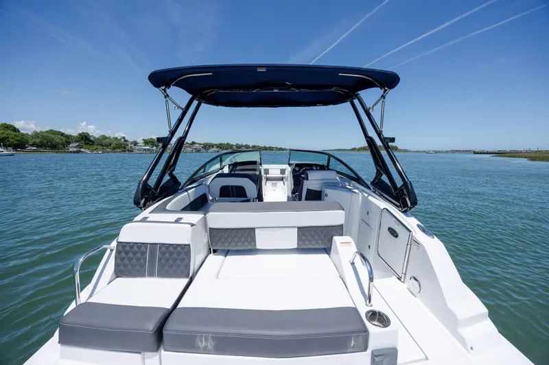 Slide: The Image of 2024 Monterey M-45 boat with sleek seating, cruising on a serene lake under clear skies. - 34