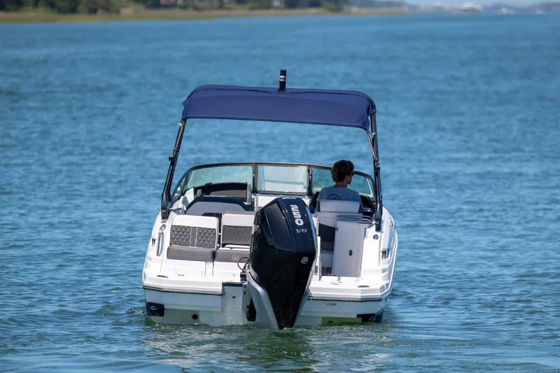 Slide: The Image of 2024 Monterey M-45 boat cruising on a serene lake with a blue canopy. - 4