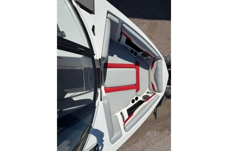 Slide: The Image of 2022 Axis T220 boat interior with red and gray seating, featuring cup holders and speakers. - 10