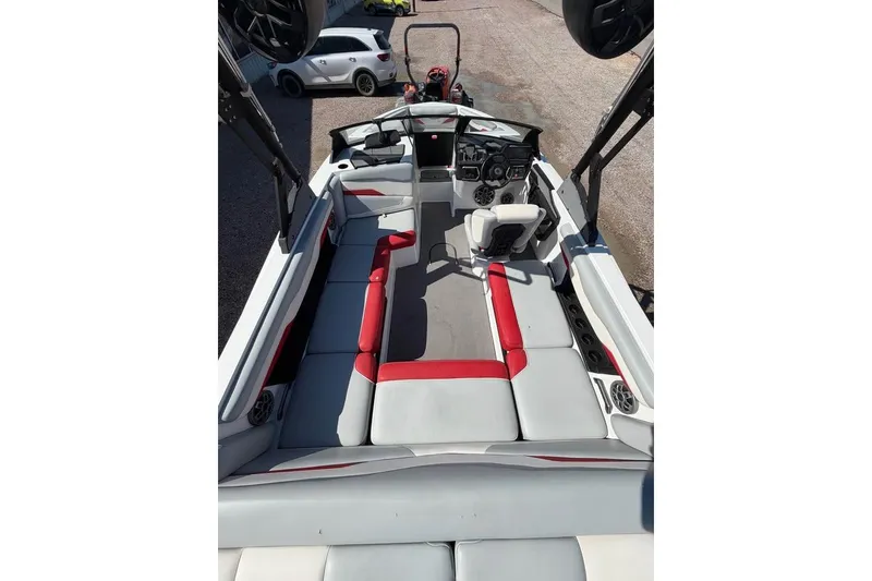 Slide: The Image of 2022 Axis T220 boat interior with red and gray seating, spacious layout, and modern dashboard. - 7
