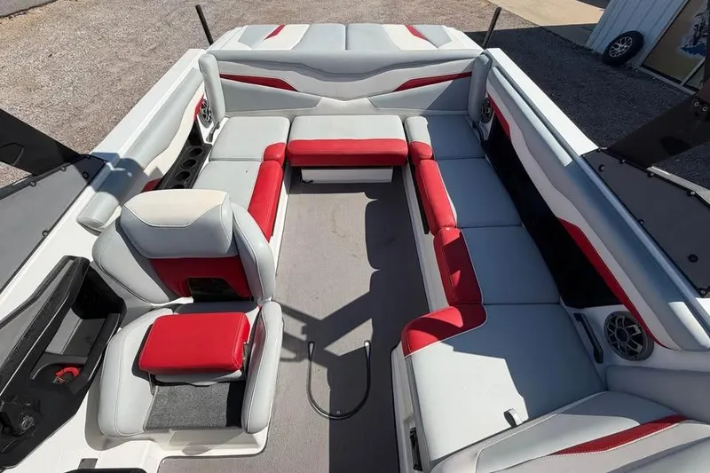 Slide: The Image of 2022 Axis T220 boat interior with red and gray seating, spacious layout. - 9