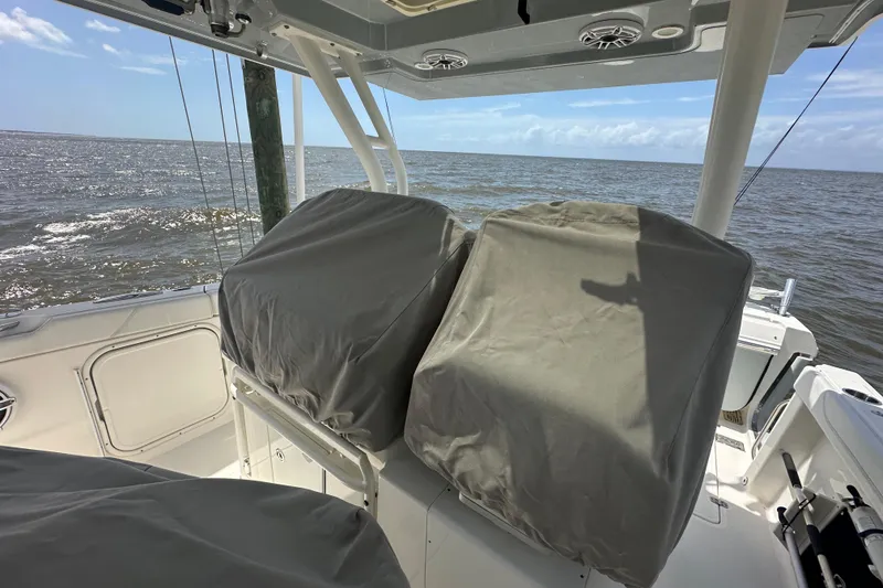 Slide: The Image of 2021 Pursuit S 328 Sport boat interior with covered seats, ocean view. - 14