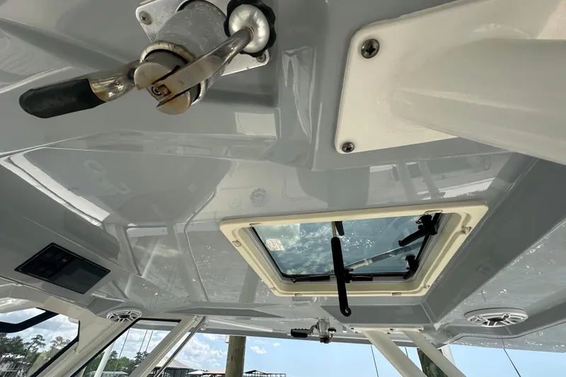 Slide: The Image of 2021 Pursuit S 328 Sport boat interior with hatch and handle details. - 16