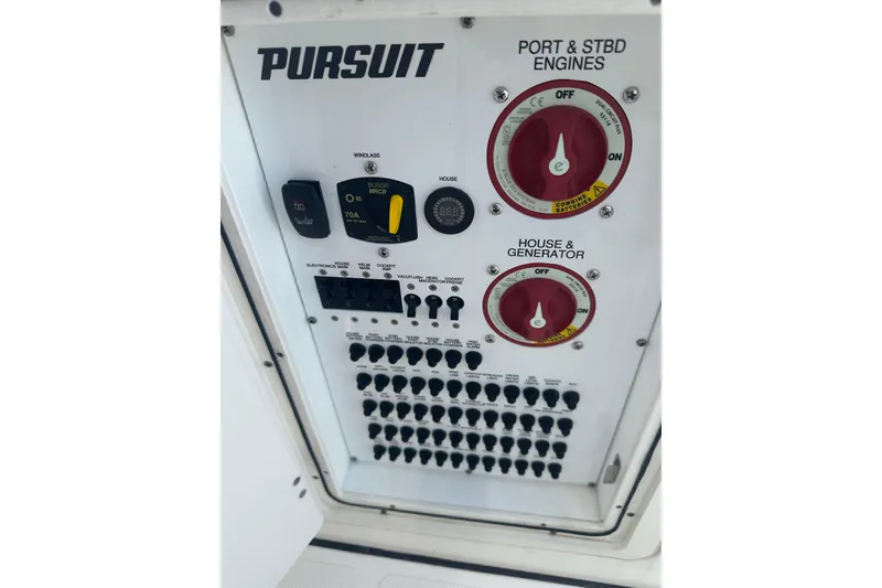 Slide: The Image of Control panel of 2021 Pursuit S 328 Sport boat with engine and generator switches. - 26