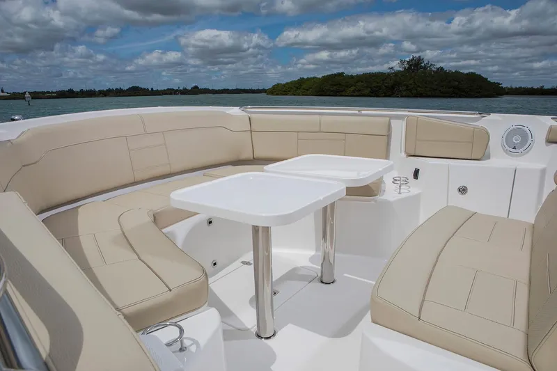 Slide: The Image of Manufacturer Provided Image: 2021 Pursuit S 328 Sport boat with beige seating and dual tables on deck. - 32