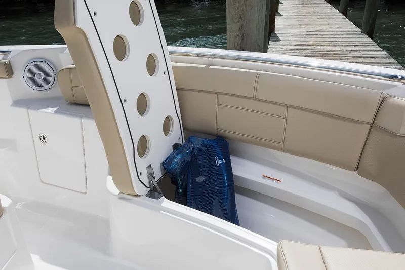 Slide: The Image of Manufacturer Provided Image: 2021 Pursuit S 328 Sport boat storage compartment with beige seating. - 33