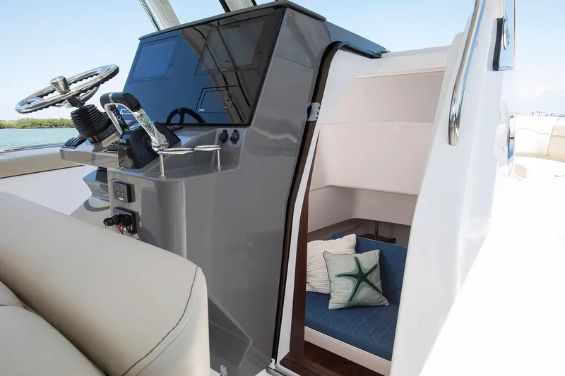 Slide: The Image of Manufacturer Provided Image: 2021 Pursuit S 328 Sport boat interior with helm and cabin. - 48