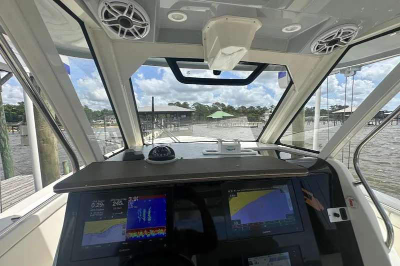 Slide: The Image of Interior view of 2021 Pursuit S 328 Sport boat cockpit with navigation screens. - 5