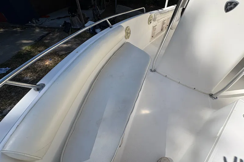 Slide: The Image of 2005 Century 2200 Center Console boat interior with cushioned seating and railings. - 12