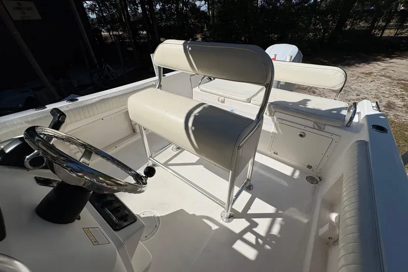 Slide: The Image of 2005 Century 2200 Center Console boat interior with steering wheel and seating. - 16